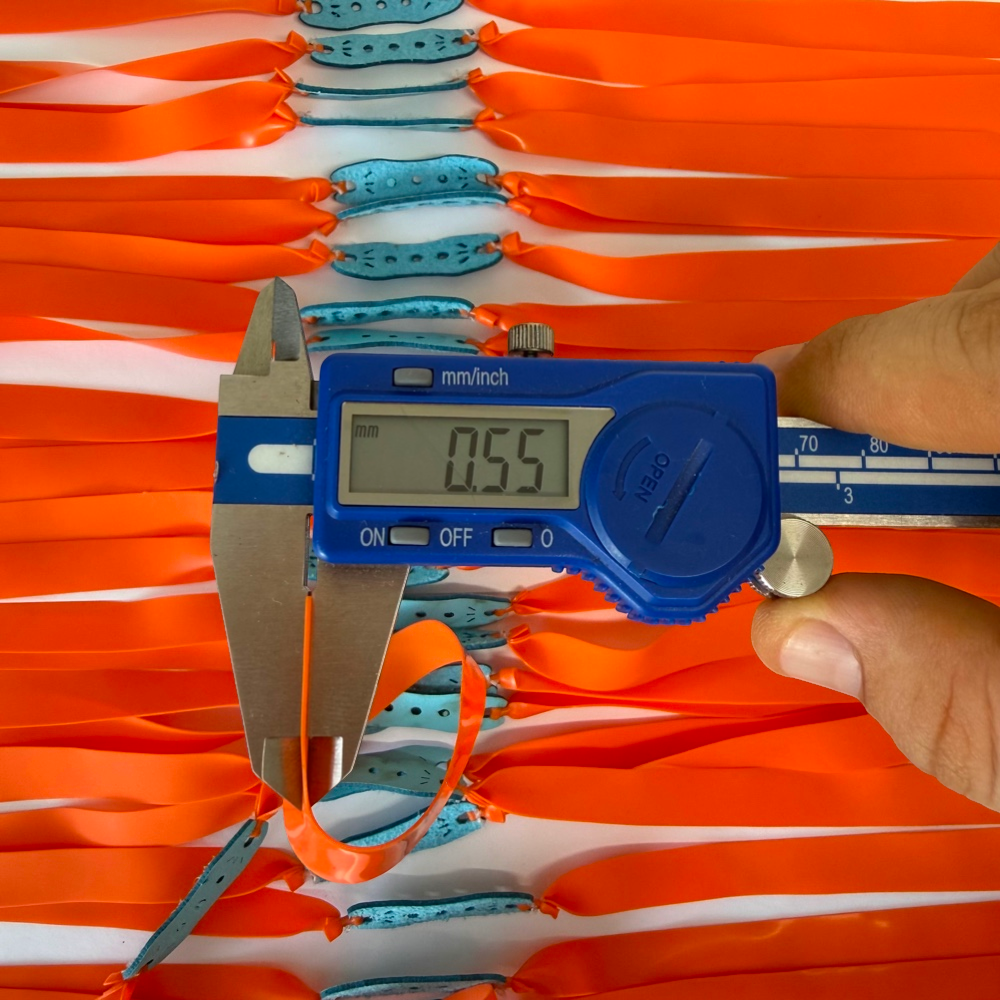 Close-up of premium natural latex band showing 0.55mm thickness and sharp orange color for improved visibility | Armament Mfg.