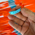 Detail view of 215mm orange flat band demonstrating consistent elasticity and controlled power for backyard practice | Armament Mfg.