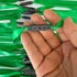 Detail view of 215mm green slingshot flat band demonstrating excellent elasticity and reliable power for precision target practice | Armament Mfg.
