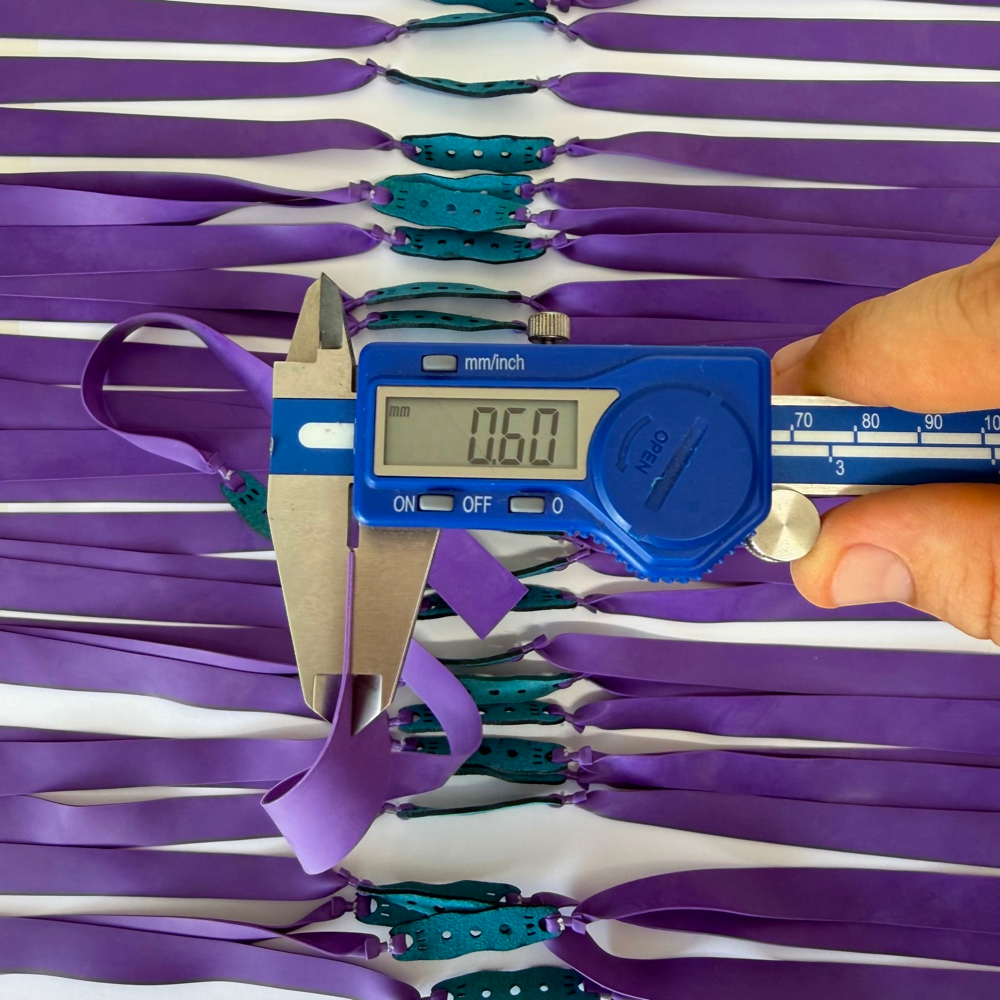 Close-up of premium natural latex band showing 0.60mm thickness and standout purple color for enhanced visibility | Armament Mfg.