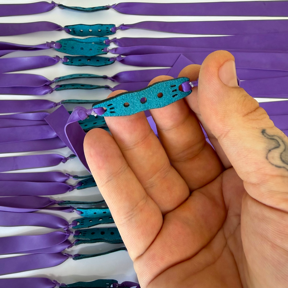 Detail view of 215mm purple flat band demonstrating consistent elasticity and controlled rebound for target practice | Armament Mfg.