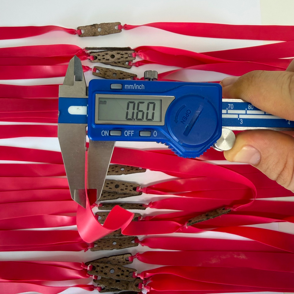 Close-up of premium natural latex band showing 0.60mm thickness and durable construction for consistent performance | Armament Mfg.