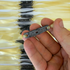 Detail view of 215mm transparent latex flat band demonstrating pouch design for balanced power and control | Armament Mfg.