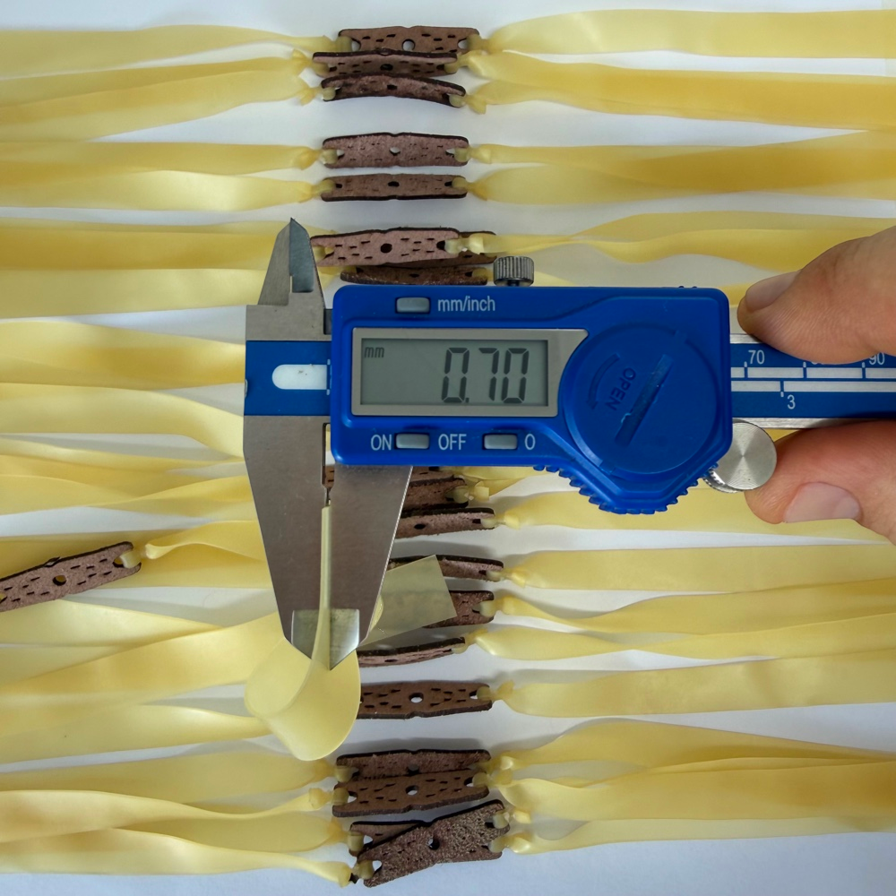 Close-up of premium natural latex band showing 0.70mm thickness and durable construction for consistent elasticity | Armament Mfg.