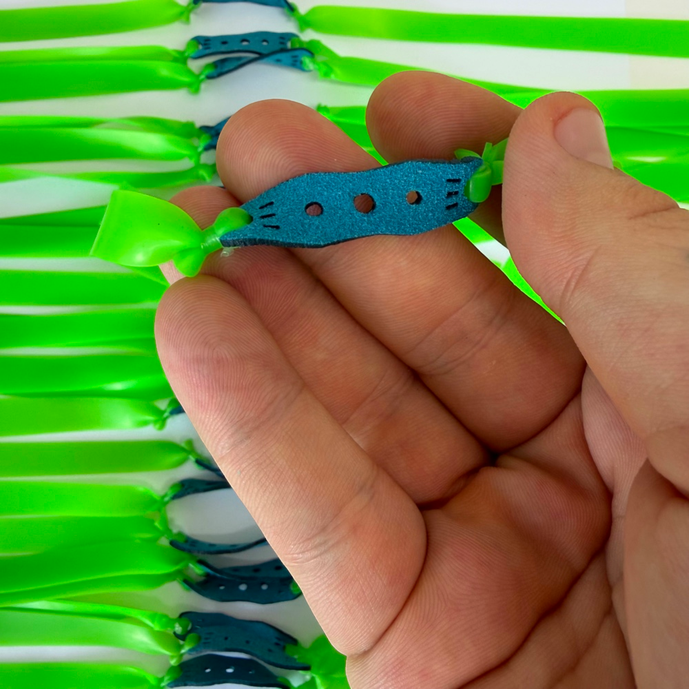 Detail view of 215mm neon green flat band demonstrating smooth draw and powerful rebound for advanced precision practice | Armament Mfg.