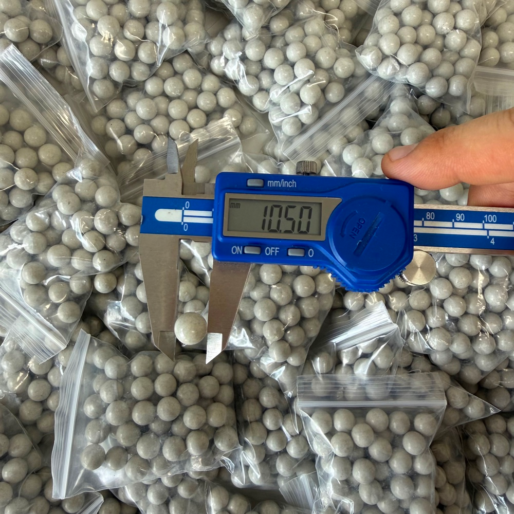 Close-up of eco-friendly magnetic clay ammo showing consistent round shape for accurate slingshot shooting | Armament Mfg.