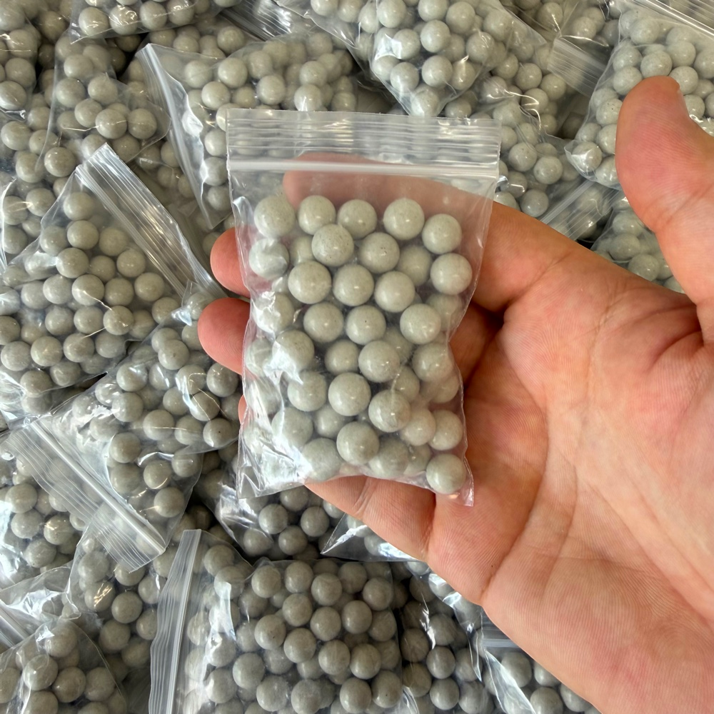Magnetic clay slingshot ammo showing consistent diameter and light grey color for target practice | Armament Mfg.
