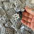 Detail view of 10.5mm biodegradable clay pellets demonstrating magnetic properties for easy retrieval | Armament Mfg.