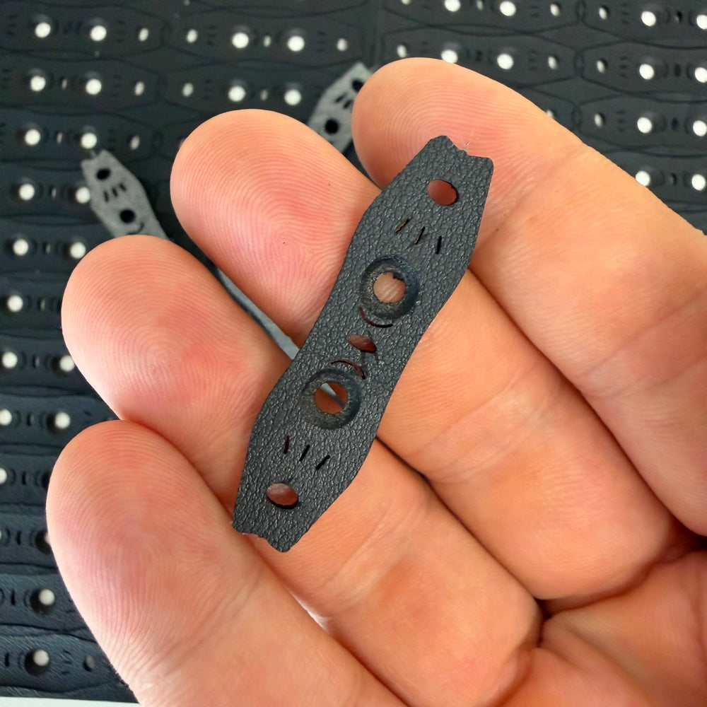 Close-up of durable microfiber slingshot pouch showing anti-slip texture and ergonomic design | Armament Mfg.