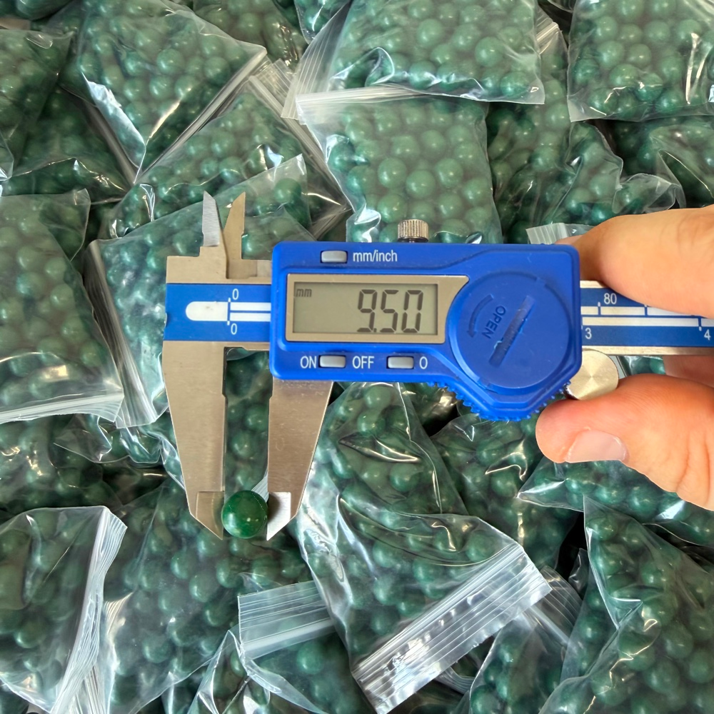 Close-up of eco-friendly magnetic clay ammo showing consistent round shape for accurate slingshot shooting | Armament Mfg.
