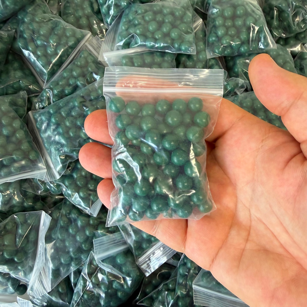Magnetic clay slingshot ammo showing consistent diameter and green color for target practice and training | Armament Mfg.