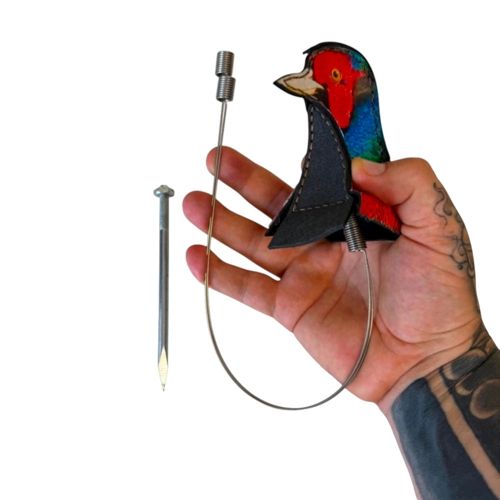 Close-up of motion-reactive wobbling target showing bird head design for dynamic feedback with steel and clay ammo | Armament Mfg.
