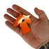 Orange powder coated rotating steel chicken head target for slingshot practice | Armament Mfg.