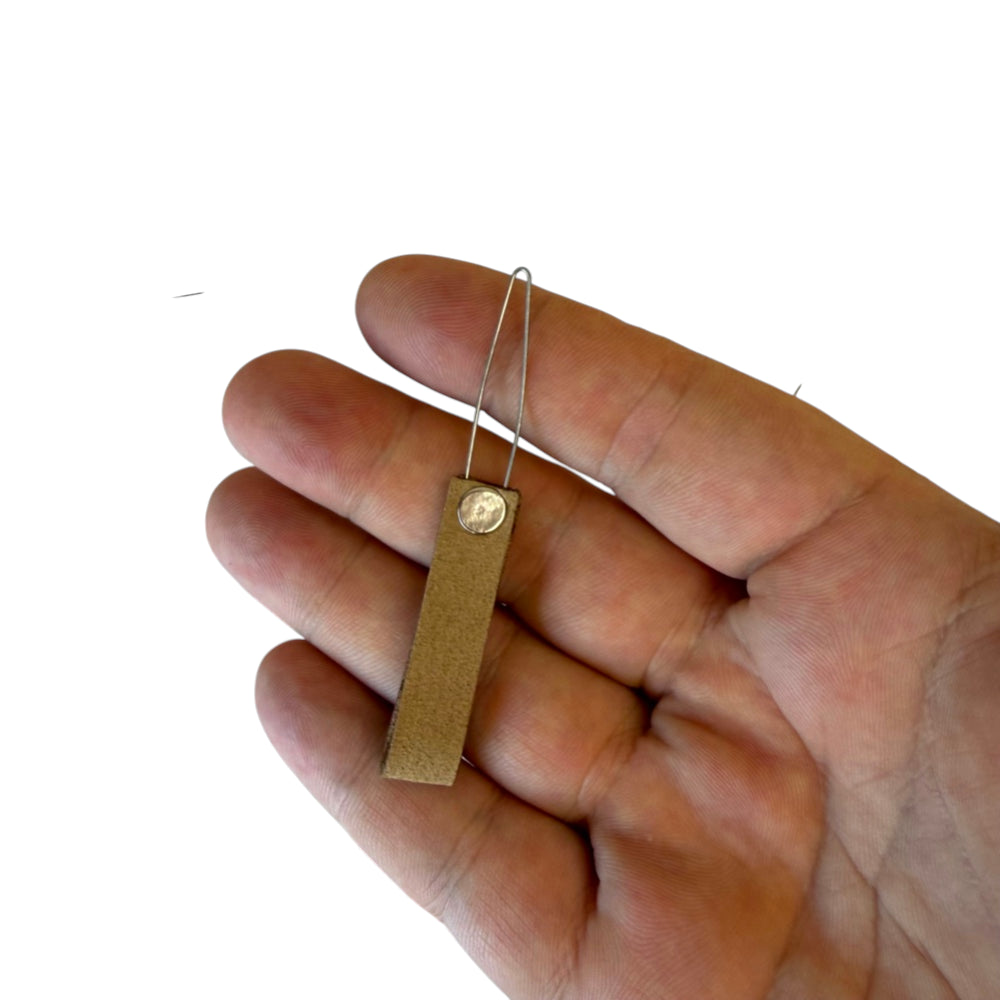 Close-up of DIY band tying tool showing 30mm pull-through design for slingshot pouch assembly | Armament Mfg.