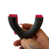 Hand holding a black slingshot with red bands on a white background