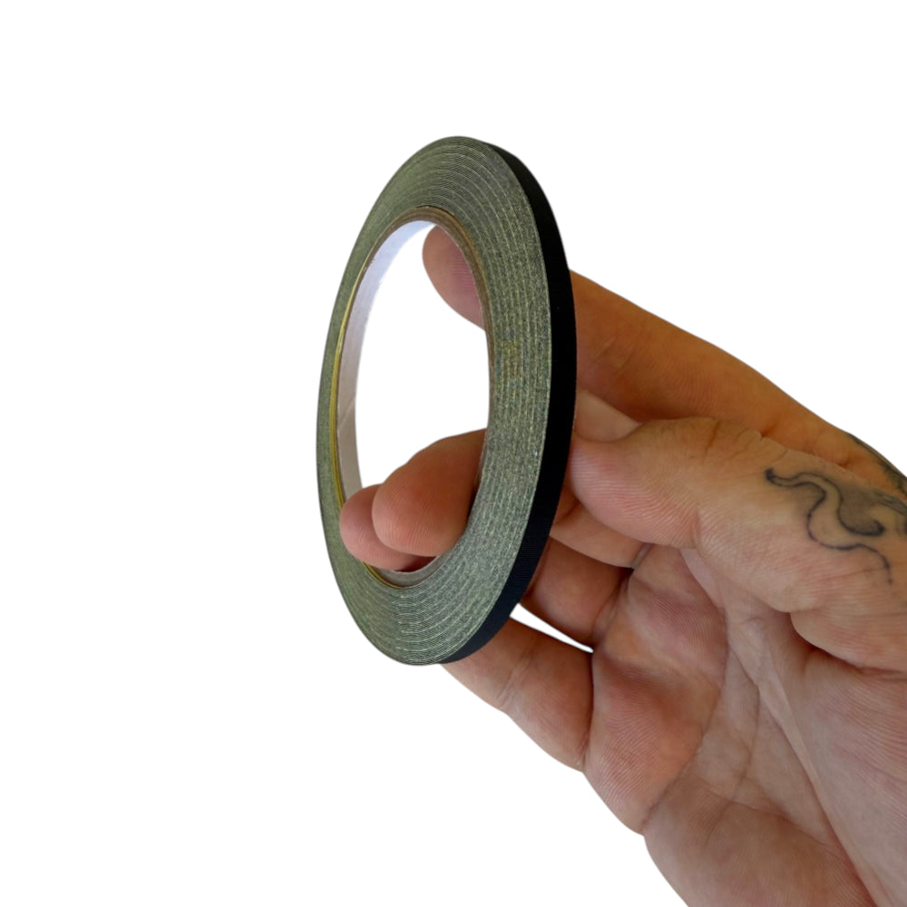 Close-up of durable slingshot band tying tape showing side profile for securing flat and tapered bands to slingshot frames | Armament Mfg.