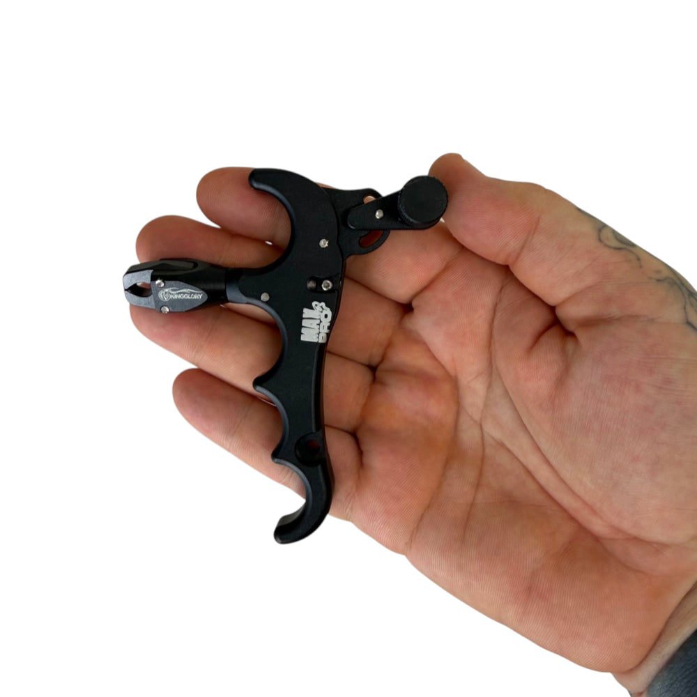 Close-up of CNC-machined four-finger release aid showing finger grooves and trigger mechanism | Armamet Mfg.