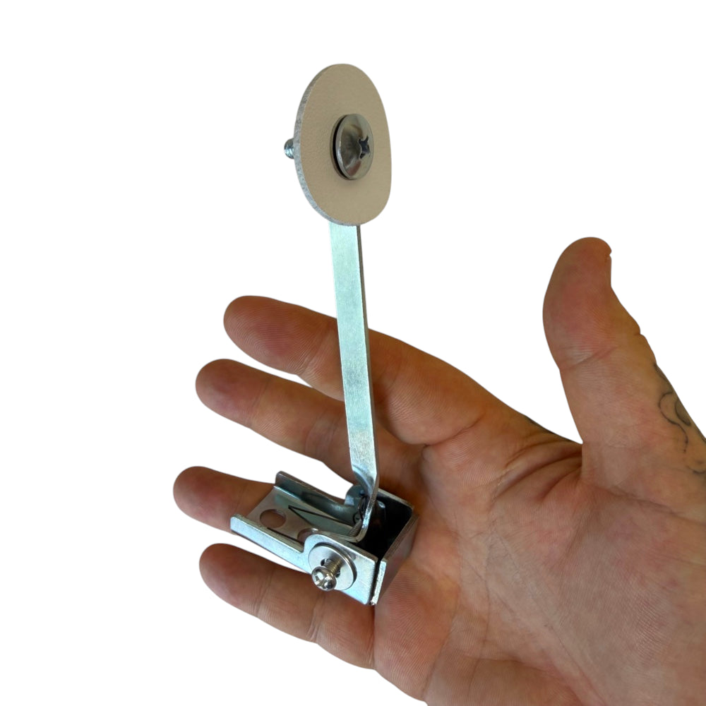 Close-up of reactive knockdown target showing linked reset mechanism for automatic stand-up action | Armament Mfg.